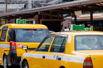 駅前で客待ちをする黄色いタクシー