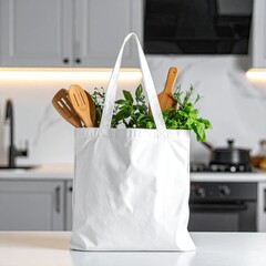 A white tote bag filled with fresh herbs and wooden kitchen utensils sits on a kitchen counter