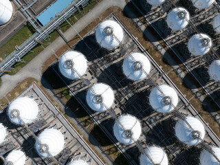 Aerial views of industrial areas with numerous large storage tanks