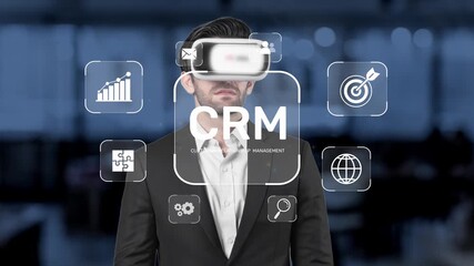 A modern businessman wearing a virtual reality headset explores customer relationship management concepts, surrounded by digital icons and analytics in a sleek office space. Raster - Powered by Adobe