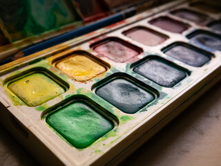 Colorful Watercolor Paint Palette Close-up - Artist Gouache Colors and Creative Art Supplies in Action.