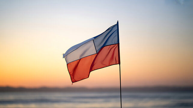 Czech Republic flag waving in the wind against a sunset sky over water