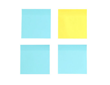Four square sticky notes, light blue and yellow, arranged in a grid pattern