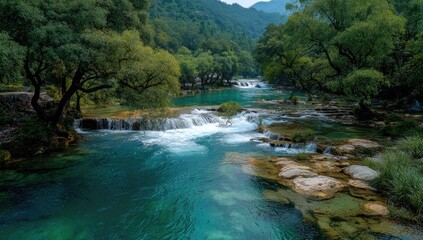 Turquoise river flowing through lush green valley with waterfalls