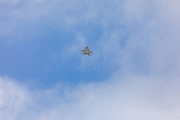 A powerful American twin-engine fighter jet flying in the sky during an air show event, demonstrating military aviation speed, agility, and maneuverability against the clouds, captured in Oregon, USA
