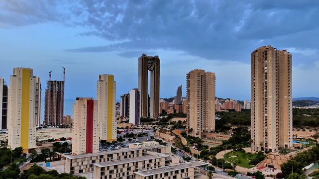 A visually stunning urban skyline showcases sleek modern buildings set against a backdrop of beautiful cloudy skies