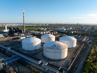 Aerial views of industrial areas with numerous large storage tanks
