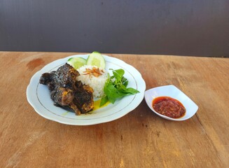 grilled meat with vegetablesNasi bebek set menu is deep fried duck served with rice,fried tempeh,fried tofu,fried cabbage,fresh vegetables and sambal or chili sauce and mango sambal Indonesian traditi