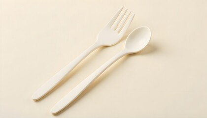 a plastic spoon and a fork with light simple background