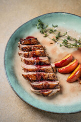 Duck breast with peach garnish