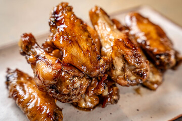 Glazed chicken wings on plate