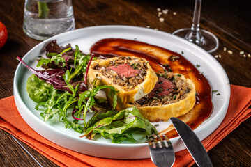 Beef Wellington with fresh salad and sauce