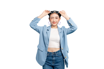 portrait Asian Woman  winking and holding sunglasses. She is wearing a blue blazer and denim jeans on PNG