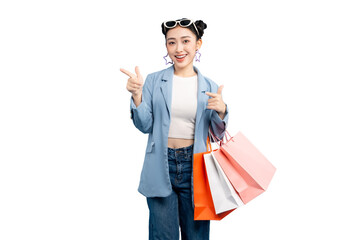 portrait Asian Woman  happy holding shopping bags and pointing her finger. She is wearing stylish outfit with a smiling face and thumbs up gesture on PNG