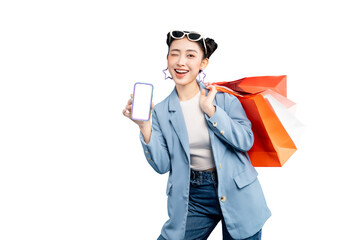 portrait Asian Woman holding shopping bags and a smartphone. She is winking and smiling, showing off a blank phone screen on PNG