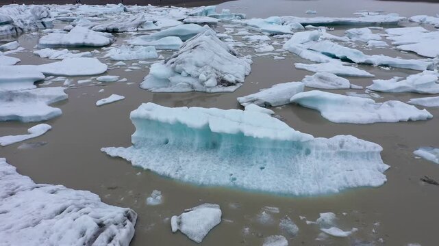  Aerial slow motion view of melting glacier and floating icebergs as result of Atlantic ocean meridian overturning circulation Gulf stream collapse