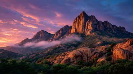 Fiery Sunrise Over Rugged Red Spires in Dramatic Mountain Range