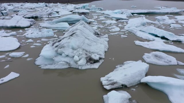  Aerial slow motion view of melting glacier and floating icebergs as result of Atlantic ocean meridian overturning circulation Gulf stream collapse