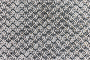 High resolution close-up of a gray geometric fabric texture with small diamond shapes. Perfect for use as a textile background, upholstery material, fashion fabric, or seamless design. Minimalist