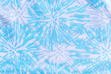 Abstract blue fabric close-up with floral pattern and textile texture. Decorative cloth surface with geometric flower-inspired shapes, modern textile design, and soft woven material. Ideal for fashion