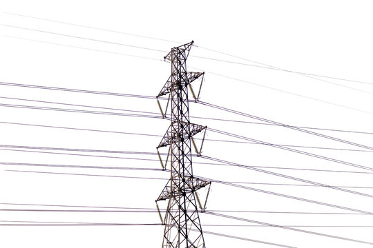 High voltage power lines suspended by a steel tower transmit electricity against a blue sky