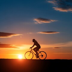 Obraz premium A silhouette of a cyclist enjoying a breathtaking sunset, showcasing the tranquil beauty of the golden hour.