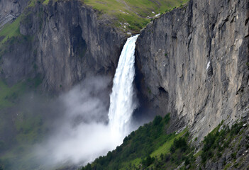 Alpine Waterfall Cascade: Majestic Cliffs and Mist