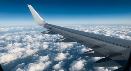 Obraz premium Airplane wing over clouds