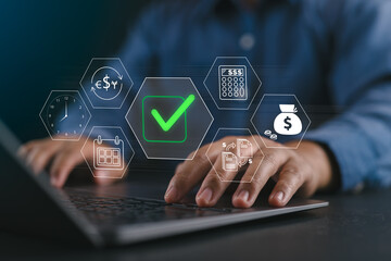 Digital financial approval concept. Businessman works on a laptop with floating digital icons representing financial operations, including a green check mark indicating successful approval.