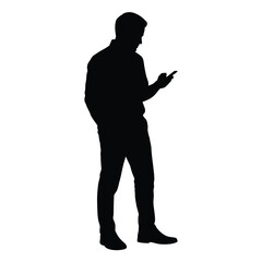 Silhouette of a man looking at his smartphone