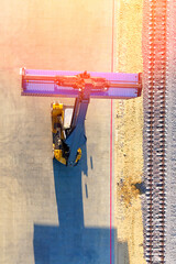 The loading of a sea container onto a ship at an onshore terminal for shipping logistics. High quality photo