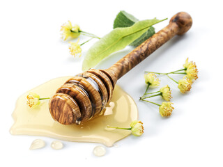 Wooden honey stick in honey puddle.