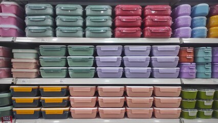 Plastic food containers with lids neatly displayed on a supermarket shelf, perfect for storing snacks, meal prep portions, and keeping food fresh longer.