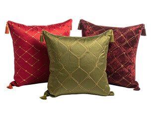 Three decorative square pillows in red, burgundy, and olive-green. 