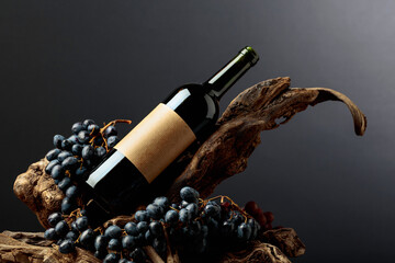 Obraz na płótnie Canvas Bottle of red wine with empty label on a old snags.