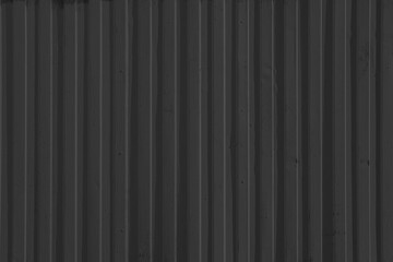 Light black corrugated metal surface with vertical ridges. Scratches, smudges, and subtle wear...