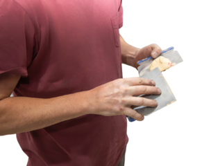Man holding sandpaper sanding wood piece