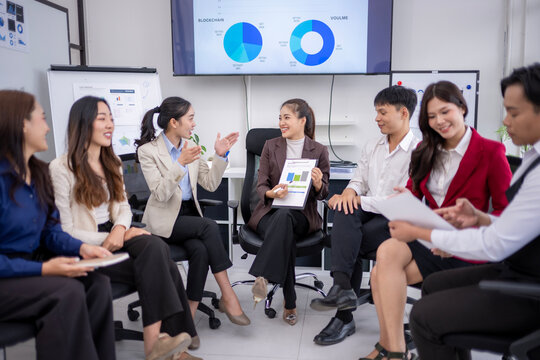 Business team discussing blockchain and volume data in office meeting