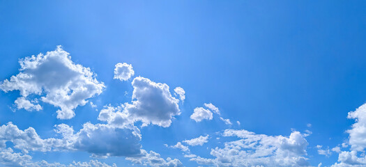 Diagonal composition banner with copy space inscription.. Blue sky filled many white clouds creating a peaceful and inspiring natural landscape scene.