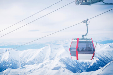Modern gondola lift connecting Kobi and Gudauri in Caucasus mountains Georgia, scenic ski resort transport with snowy peaks, popular winter tourism, skiing and snowboarding travel destination. © Evaldas