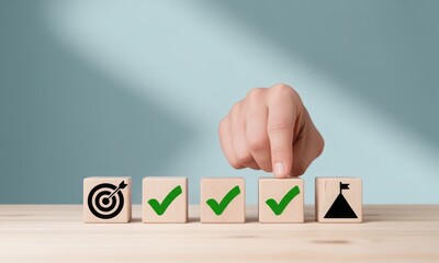 Hand placing final block in successful goal achievement sequence