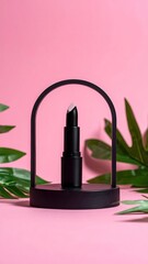 Black lip balm in minimalist arch display, set against a pink backdrop with lush green foliage