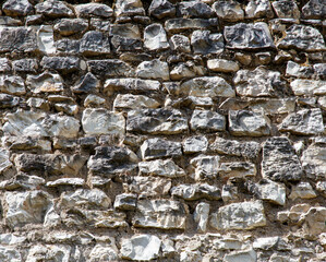 A wall made of stone with a few cracks