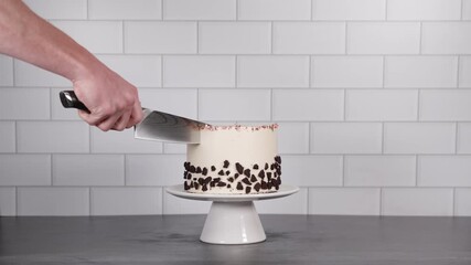 Close-up of a knife slicing through a rich cookie cake topped with gold foil accents, perfect for dessert, baking, or culinary visuals. - Powered by Adobe