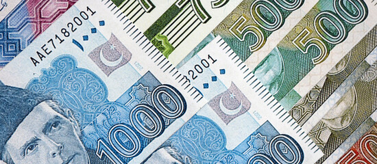 Pakistan rupees banknotes close up. The current Pakistan money bills lies on table in big amount