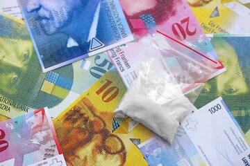 Swiss franc banknotes and cocaine pack. The current francs money bills and narcotic substance