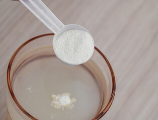 Pour powdered electrolytes into a glass, magnesium and water-soluble vitamins