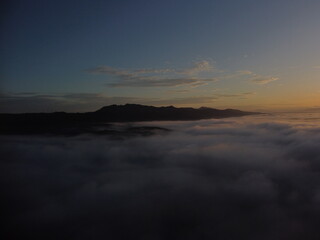 Fototapeta premium Golden Sunrise Over the Clouds Captured from a Drone – Aerial Landscape ViewDescription Beautiful sunrise above the clouds taken from a drone, showing a dramatic and scenic aerial landscape.