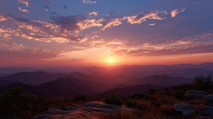 Serene sunset over mountainous landscape with vibrant clouds illuminated by golden light, creating a peaceful and tranquil atmosphere in nature.
