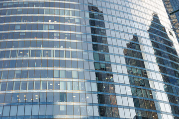 Glass facade office building skyscraper,  Contemporary High tech architectural design,  Reflections in the windows